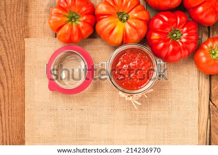 Tomatoes and tomato sauce, tomato puree on a wooden rustic table