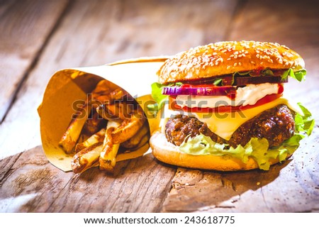 Delicious burger and chips, hand-made in the house on rustic table