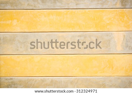 The wall in beige and yellow wide belts.