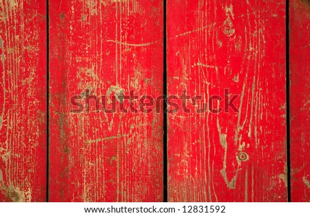 Wood with chipped red paint. Grunge style background