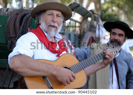 BUENOS AIRES, ARGENTINA - DEC 4: Gauchos playing guitar and singin traditional songs in Gaucho National Day Festival. Dec 4, 2011 in Buenos Aires, Argentina