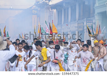 PHUKET - OCTOBER 10: an unidentified people who have faith of a Chinese Taoist shrine carry a palanquin housing a Chinese God idol in a street October 10, 2013 in Phuket Province, Thailand.