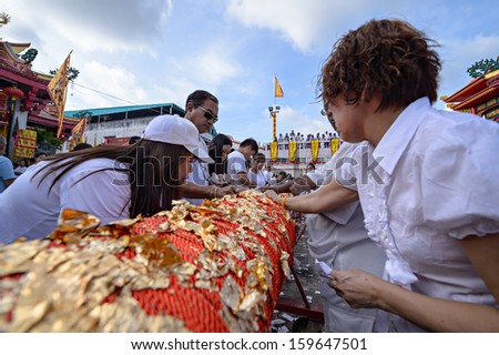 PHUKET - OCTOBER 14: an unidentified People a Perform a ceremony Set The sacred wood poles is the symbol of the beginning Phuket Vegetarian Festival October 14, 2012 in Phuket Province, Thailand.