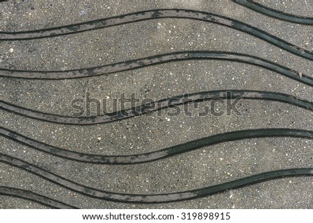 Abstract curved lines and surfaces of wet cement floor for design, website, wallpaper, background