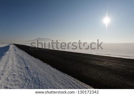 The Altaian sun over the snowy valley on the way to the Belokurikha