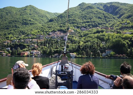 Tourists on the boat tour on the lake Como looking at the beautiful views