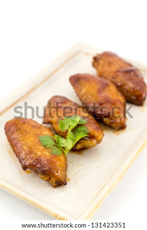 Chicken wings and red sauce with coriander isolated on white background