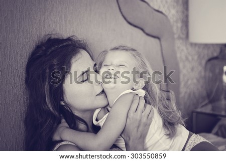mother daughter in the morning bed
