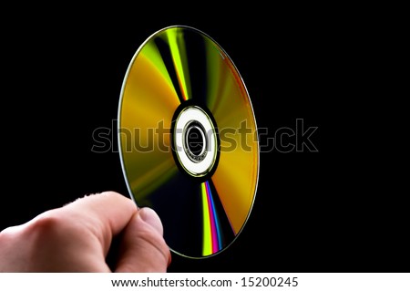 abstract cd dvd blue-ray disk in hand isolated on black