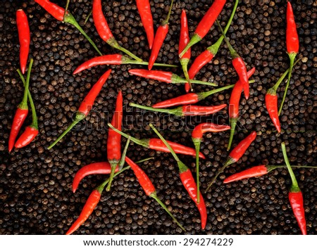 closeup red peppers on black peppercorns