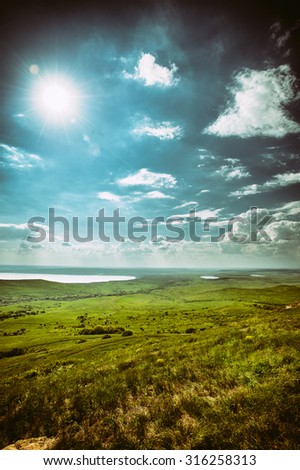 Photo of dramatic beautiful landscape with grassy and land lake under sunny skies