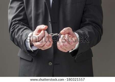 corporate man held in bracelets
