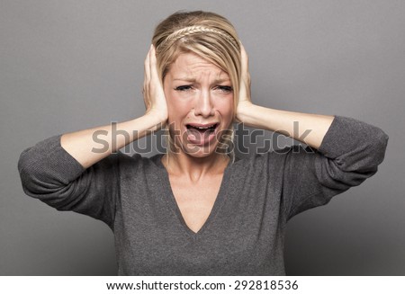 frustrated young woman having painful headache, covering closed ears, annoyed by loud noise, ignoring someone, not wanting to hear their side of story