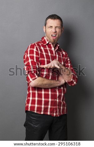 disgusted 40\'s man wearing casual shirt showing teeth and using body language for revulsion and aversion