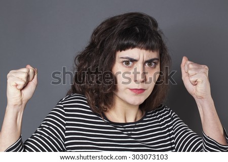anger and fear concept - furious 20s woman with brown hair looking angry,studio shot