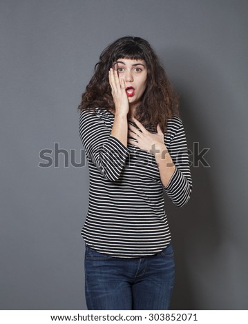 disillusion and fear concept - disillusioned 20s woman with brown hair looking scared and disappointed,studio shot