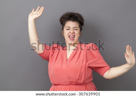 success concept - dynamic young fat girl dancing wearing a vintage dress expressing her achievement and happiness