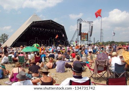 GLASTONBURY,UK - JUNE 27: A festival crowd of music fans gather by the Pyramid Stage at  Glastonbury Festival on 27th June, 2010 at Pilton Farm, Somerset.