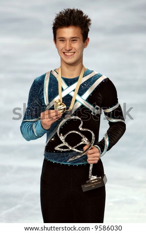 Canada\'s figure skater Patrick Chan poses after winning a gold medal in the men\'s single competition in figure skating.