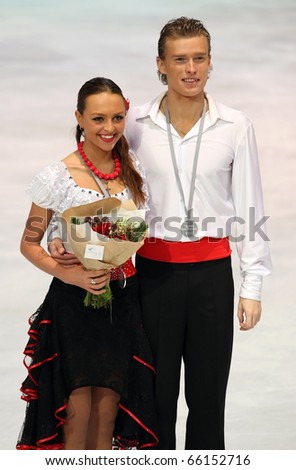 PARIS - NOVEMBER 27: Ekaterina RIAZANOVA / Ilia TKACHENKO of Russia pose at the medal ceremony after winning silver at Eric Bompard Trophy on November 27, 2010 in Bercy, Paris, France.