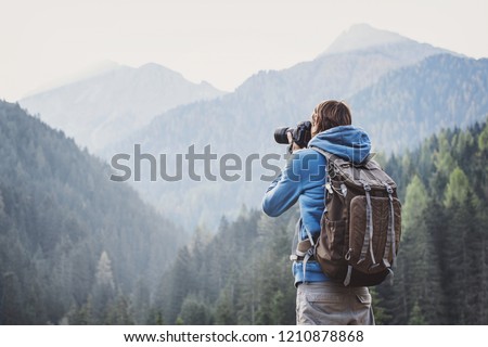 Similar – Man photographing landscape from observation deck