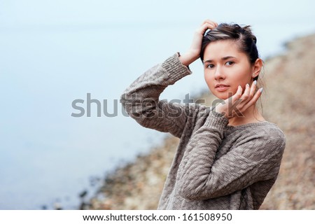 Fashion portrait of a girl on the sea