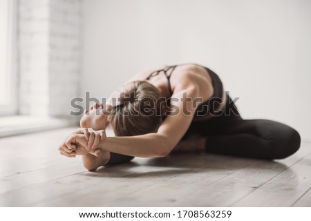 Girl doing fitness exercise, practicing yoga in class, young woman meditating at home. Training, fitness, workout, meditation, yoga, self-care, relaxation, pilates, healthy lifestyle concept