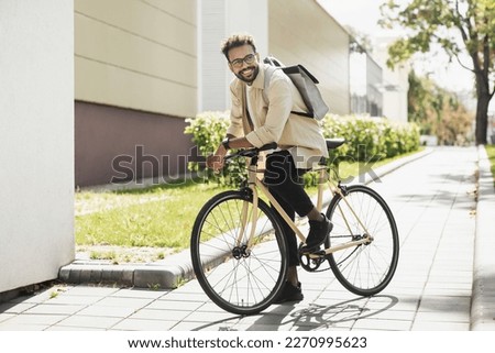 Similar – Foto Bild Ein junger Mann  fährt mit seinem Mountainbike auf eine mit Löwenzahn gespickten Wiese