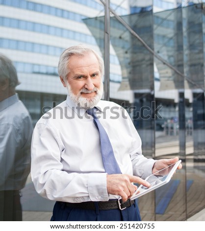 Senior men using digital tablet outdoors