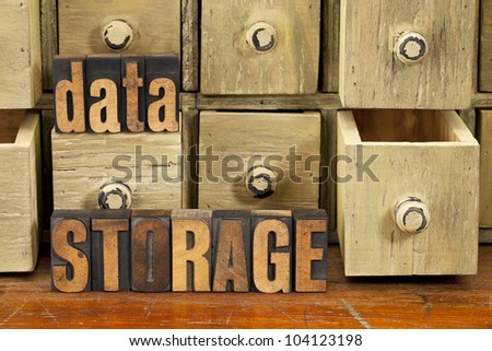 data storage concept - words in vintage letterpress wood type and primitive rustic wooden apothecary drawer cabinet