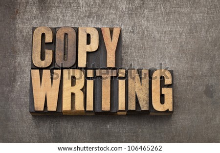 copywriting word - vintage letterpress wood type on a grunge metal background