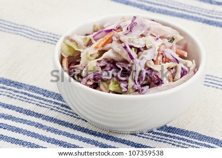 bowl of coleslaw salad - side dish on a tablecloth