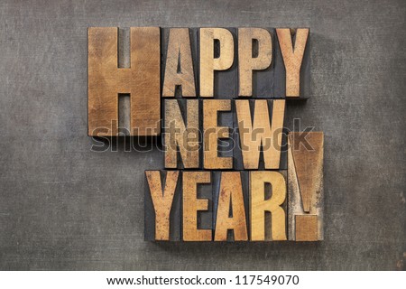 Happy New Year! - text in vintage letterpress wood type blocks on a grunge metal background