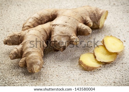 ginger root slices on a rustic white painted barn wood background
