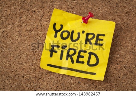 you are fired note - handwriting on orange sticky note