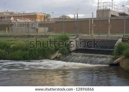 Water reclamation plant with processed and cleaned sewage flowing out to the river