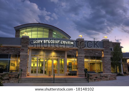Lory Student Center of Colorado State University, Fort Collins; entrance to a modern campus building with lights on at dusk