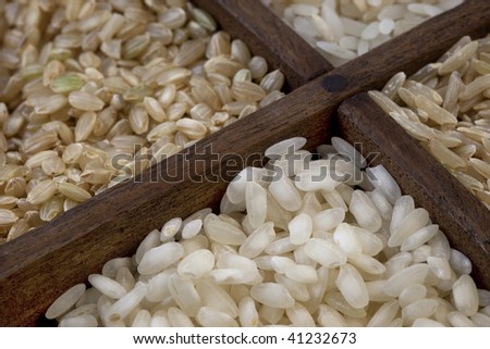 four rice grains in a vintage wood drawer with dividers - focus on white arborio rice used for traditional Italian meal, risotto