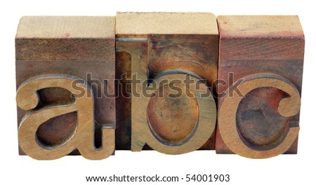 a, b, c - first letters of alphabet in vintage wooden letterpress type blocks, stained by color inks, isolated on white