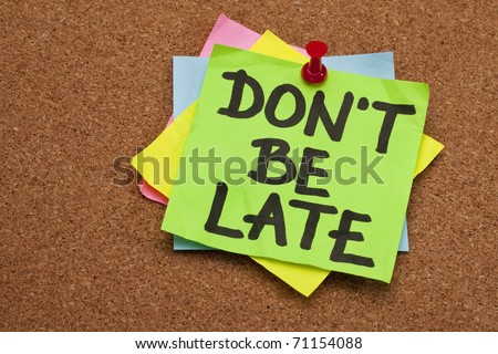 don\'t be late reminder - stack of color sticky notes against cork bulletin board