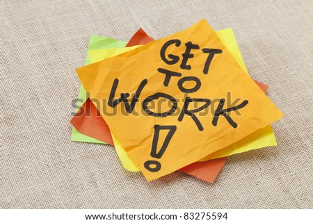 Get to work! A motivation reminder on a stack of sticky notes.