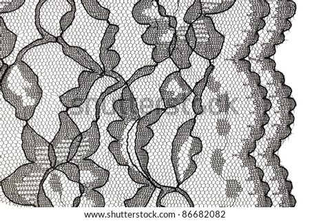 background and edge of black lace fabric with floral motif against white background