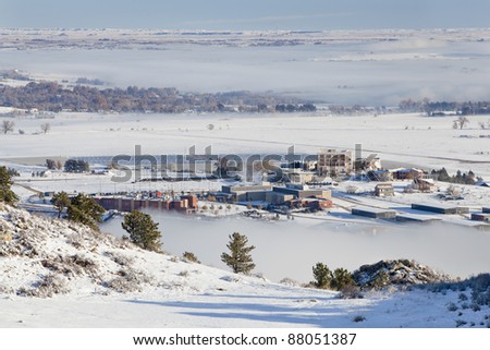 foothills of Fort Collins, Colorado with university building and solar farm, a winter scenery with snow and fields of fog
