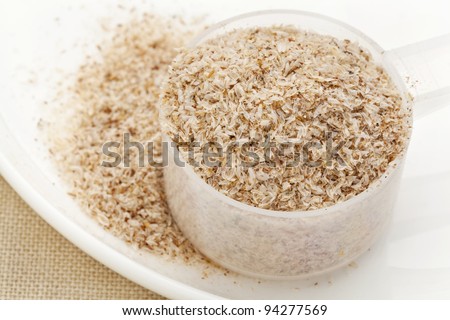 measuring plastic scoop of psyllium seed husks - dietary supplement, source of soluble fiber