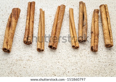 cinnamon sticks on a rough white painted barn wood background