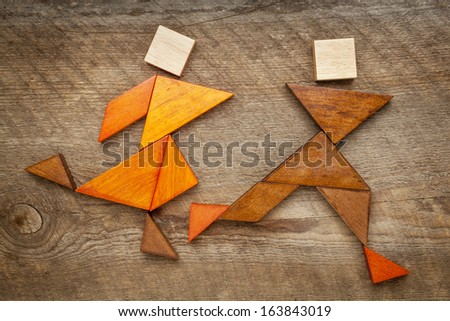 a couple of runners or athletes - abstract figures  built from tangram wooden pieces, a traditional Chinese puzzle game, artwork created by the photographer