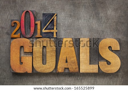 2014 goals - New Year resolution concept - text in vintage letterpress wood type blocks against grunge metal