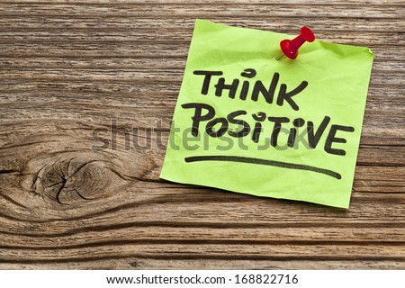 think positive reminder note against grained weathered wood
