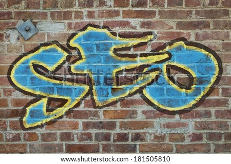 SEO - (search engine optimization acronym) graffiti style text on a old grunge brick wall