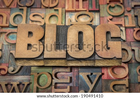 blog word in wood type against background of letterpress printing blocks